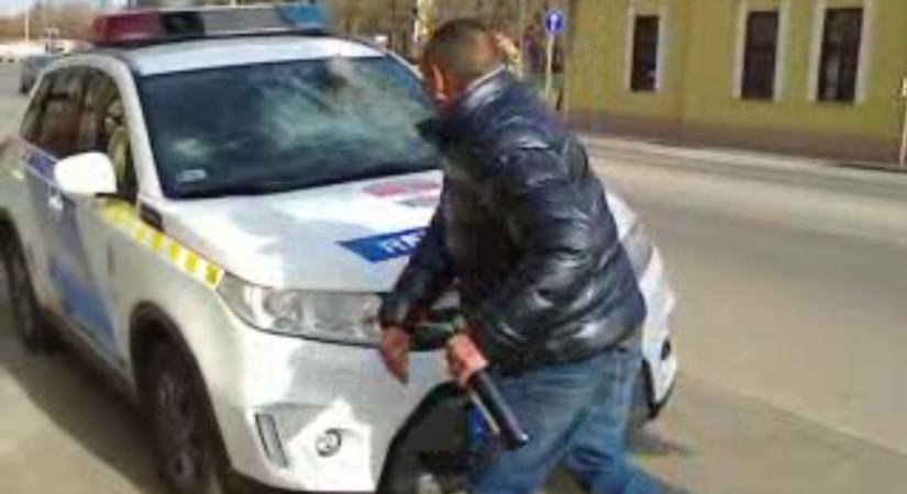 VIDEÓ: Borosüveggel a kezében törte be a rendőrautó szélvédőjét az ittas férfi