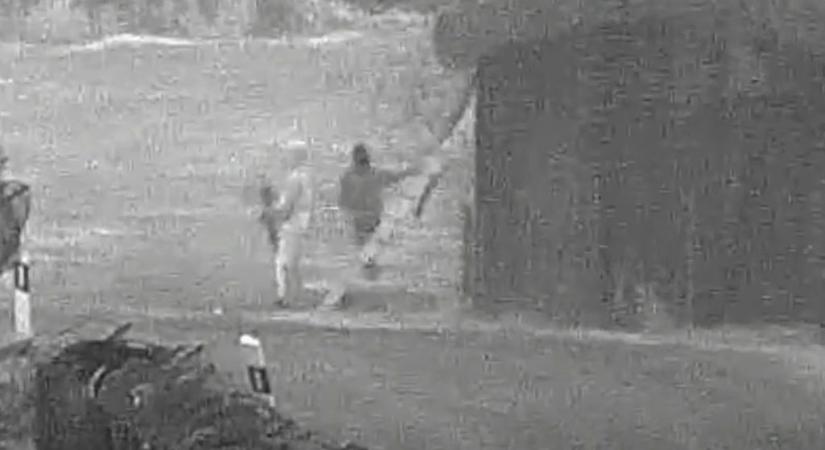 Videón, ahogy gépkarabéllyal biztosítja a migránsok határon való átjutását egy férfi
