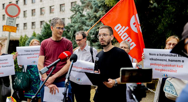 Kézikocsival jelentek meg a tiltakozók a minisztériumnál, katona fogadta őket