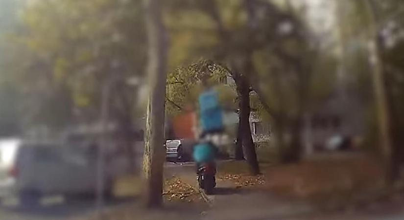 Videón, ahogy egy motoros futár elhagyja az ételhordót és meglóg a rendőrök elől
